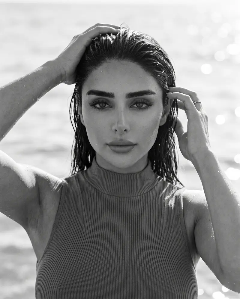 Wet-hair portrait against a glittering out-of-focus sea